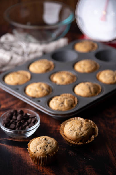 istock chocolate chip muffin on dark wooden board 1255954472