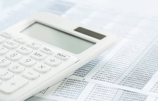 istock Finance. White calculator on financial graphs on desk 1255956259