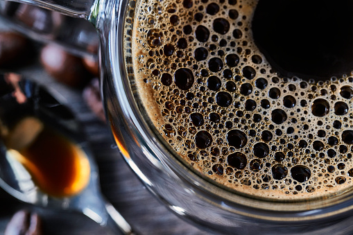 Espresso coffee cup on vintage table with roasted coffee beans