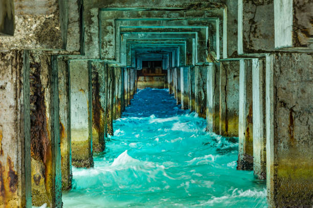 World War II cement pier on Midway Island showing the understructure. Ocean and beautiful colors.