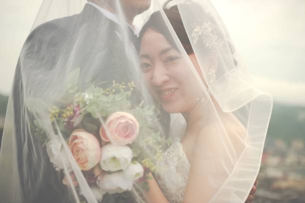 Portrait of Asian Bride holding bouquet