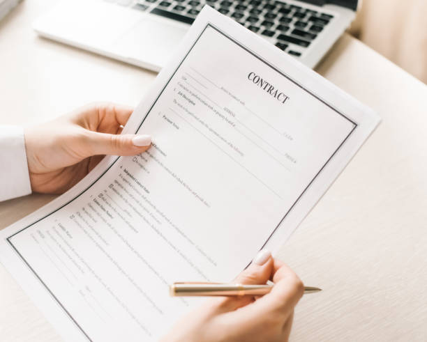 istock reads a contract and holds a metal pen 1255960969