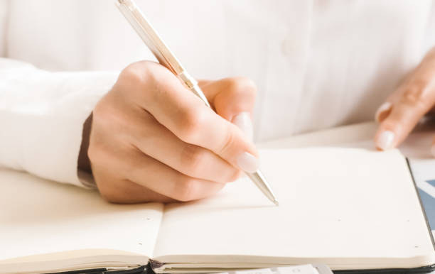 istock The woman's hands are writing note and coffee cup in open spect and light gold in morning 1255960976