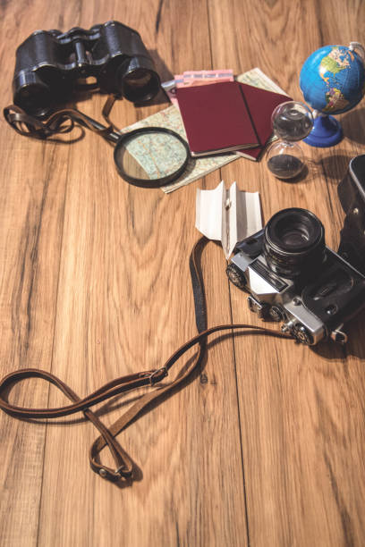 istock Traveling gadgets on wood table background 1255962158