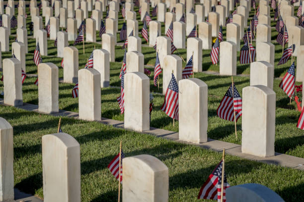 Military Headstones Decorated with Flags for Memorial Day Military Headstones Decorated with Flags for Memorial Day national cemetery stock pictures, royalty-free photos & images