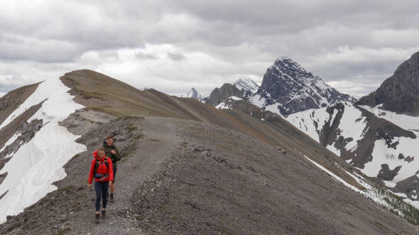 istock Young mountaineering couple walk along mountain ridge 1255962452