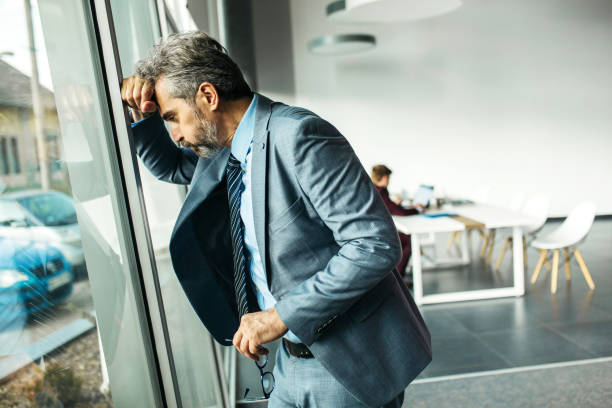 istock Frustrated senior businessman standing next to office window 1255962465