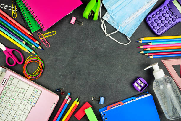 istock School supplies and COVID 19 prevention top view frame on a chalkboard background 1255962748