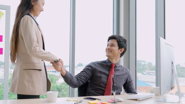 istock Two business people talk project strategy at office 1255965124