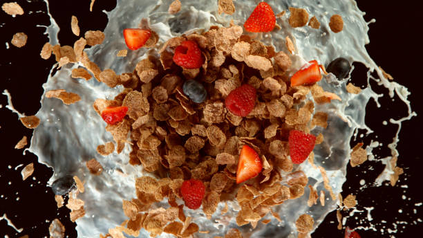 istock Freeze motion of rotating cereal pieces with milk splash 1255965285