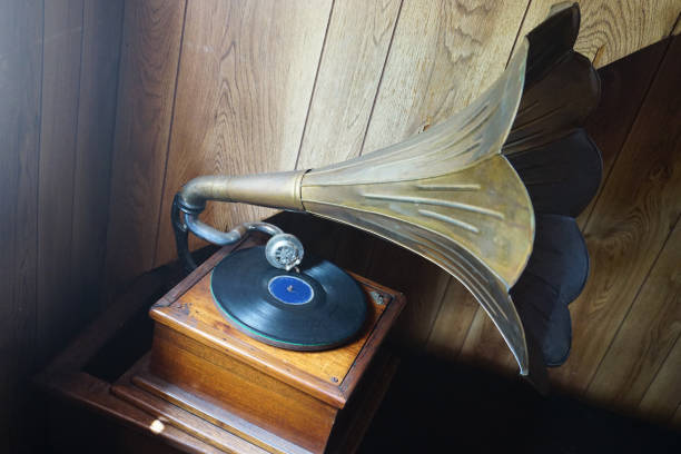 istock Turntable with old megaphone in the foreground with wooden base, on old table 1255966392