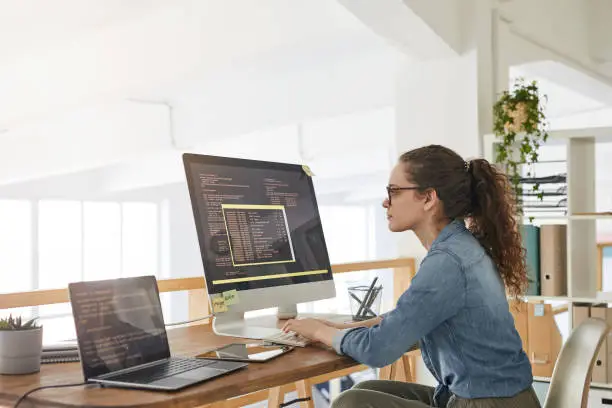 Photo of Young Woman Writing Software Code