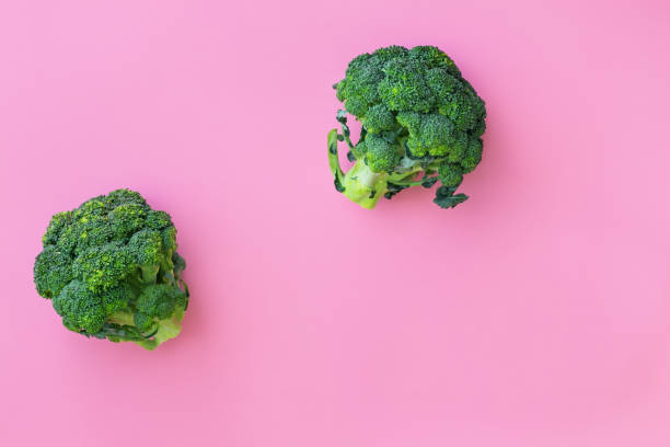istock Fresh green broccoli on pink background 1255967165