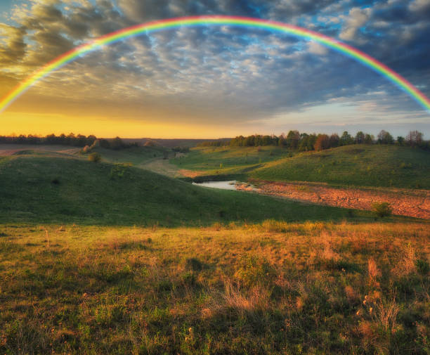 istock Rainbow over the meadow. picturesque spring morning 1255967906