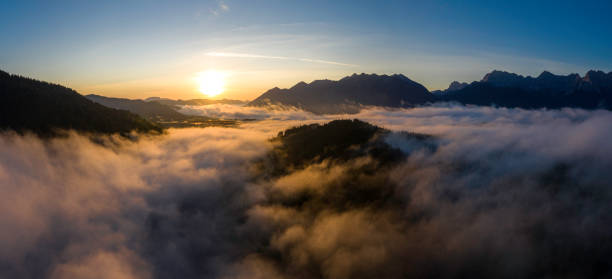 istock Aerial sunrise above cloud inversion in the mountains 1255971038