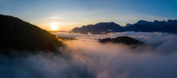 istock Aerial sunrise above cloud inversion in the mountains 1255971223