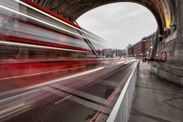 istock Traffic on the Tower Bridge at night in London - Toned Image 1255971580