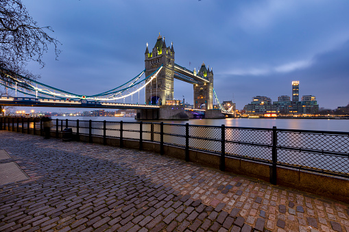 London Tower Bridge illuminated at night over River Thames.