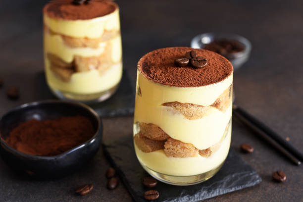 istock Classic tiramisu in a glass on a dark background. 1255972248