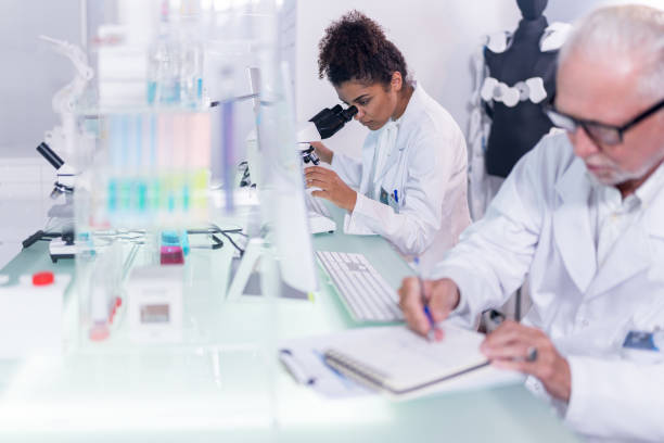 istock Multi ethnic laboratory team at work. Senior doctor working on exoskeleton project 1255972596