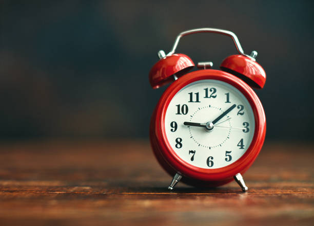 istock Alarm Clock on Wooden Desk 1255976201