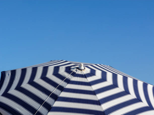 istock Pattern of a umbrella, over the sky 1255976497