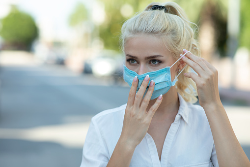 Woman wearing face mask because of air pollution or virus epidemic