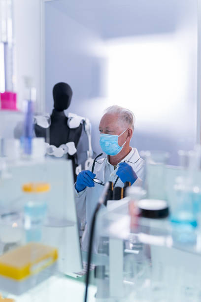 istock Laboratory worker in protective workweawr. Senior doctor focused on research 1255978180