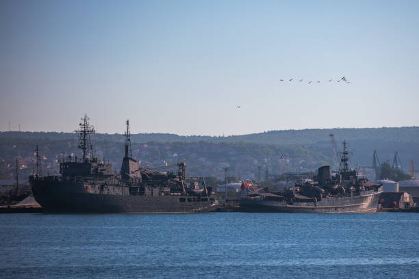 istock Military ships moor in sea harbour 1255981848