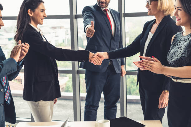 istock Business people handshake in corporate office 1255982014