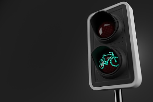 Green bike symbol inside traffic light on grey background. 3d illustration