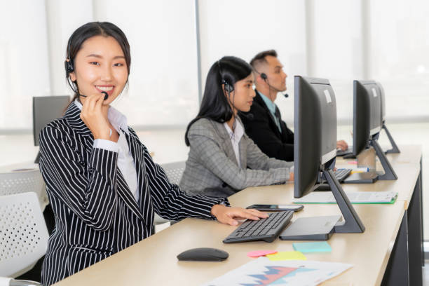 istock Business people wearing headset working in office 1255983210