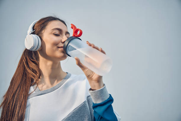 istock Sportive Caucasian lady restoring her water balance 1255984254