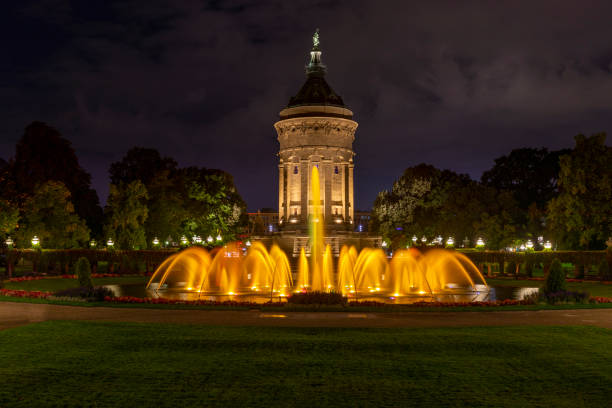 Historical watertower in German public park with no people Illuminated historical building in Rosengarten public park in Mannheim mannheim photos stock pictures, royalty-free photos & images