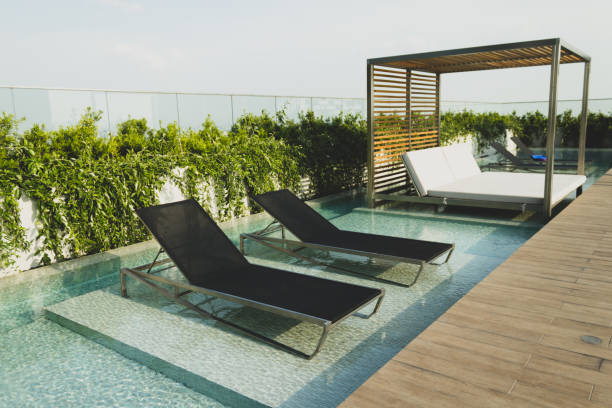 istock Pool with wood open copyspace area.  Beautiful clean swimming pool with bright blue water.  Luxury relaxation and lifestyle travel concept. 1255985984