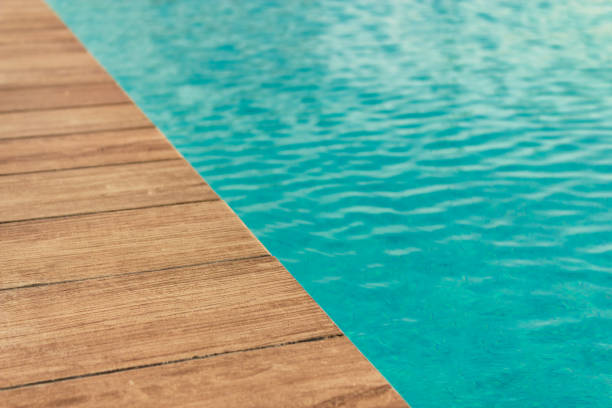 istock Pool with wood open copyspace area.  Beautiful clean swimming pool with bright blue water.  Luxury relaxation and lifestyle travel concept. 1255985985