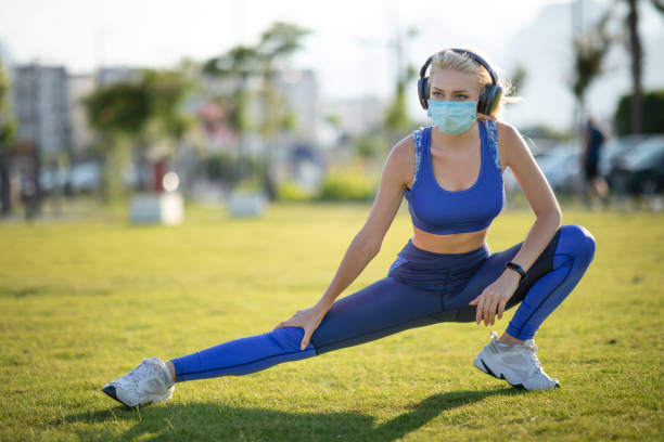 istock Young woman stretching outdoor 1255986081