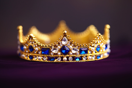 Gold jeweled crown on velvet