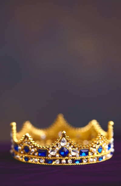 istock Gold jeweled crown on velvet 1255986121