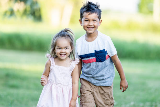 istock Adorable siblings playing outside together 1255986935