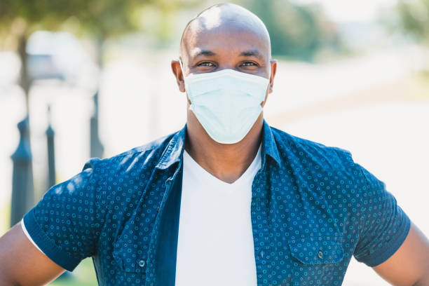 istock Handsome man with protective mask smiles for camera 1255989133