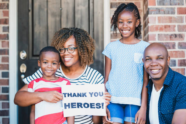 istock Portrait family showing support for essential workers during COVID-19 1255989136