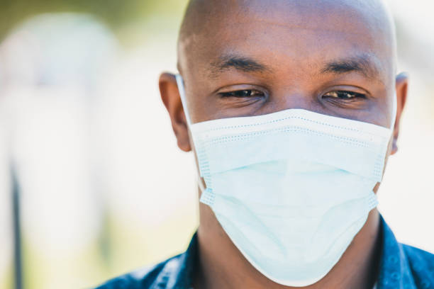 istock Tired man wearing protective face mask 1255989235