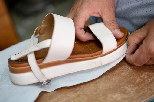 Shoemaker is repairing sandals