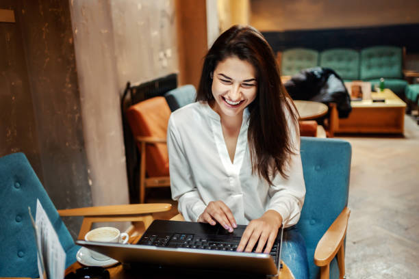 istock Business woman using laptop at a cafe 1255990544