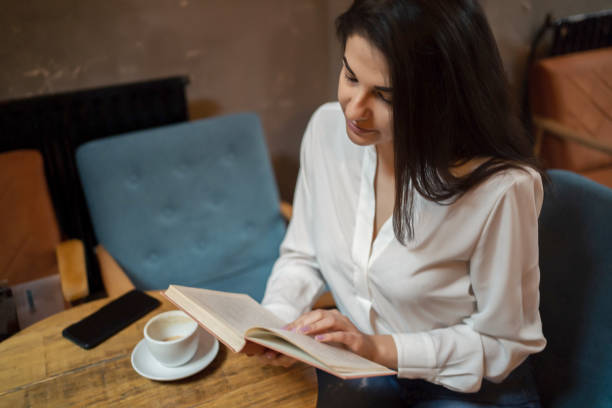istock Beautiful woman reading romantic literature 1255990557