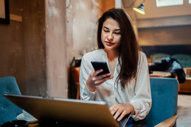 istock Business woman at a cafe texting message 1255990605