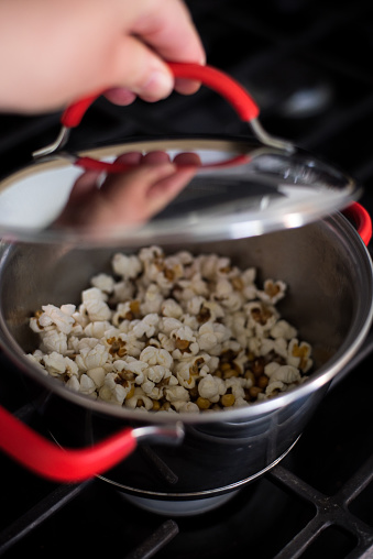 popcorn, stove, hand woman