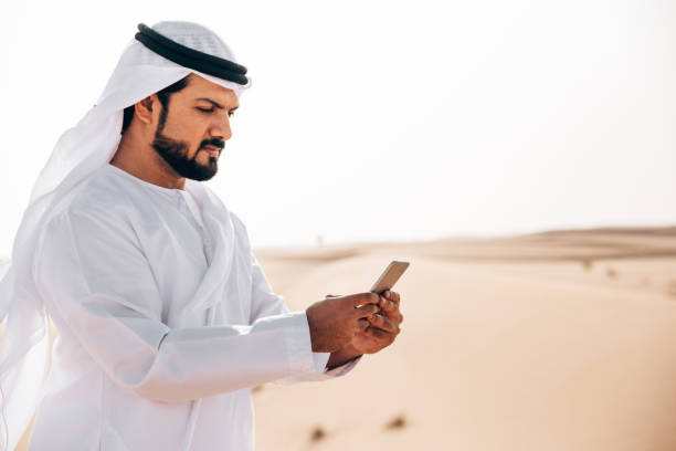 istock arab man on the phone in the desert 1255990863