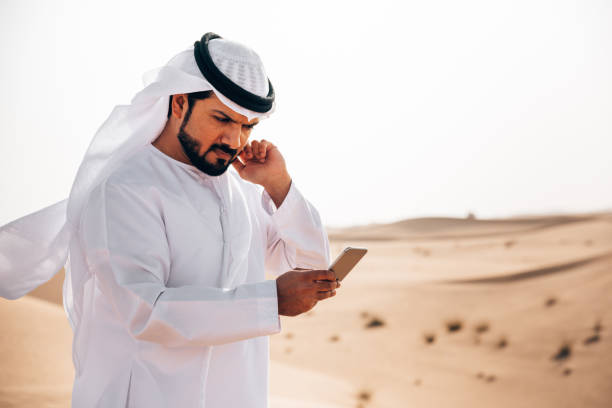 istock arab man on the phone in the desert 1255990898
